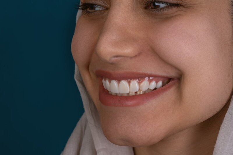 Older adult smiling showing healthy teeth