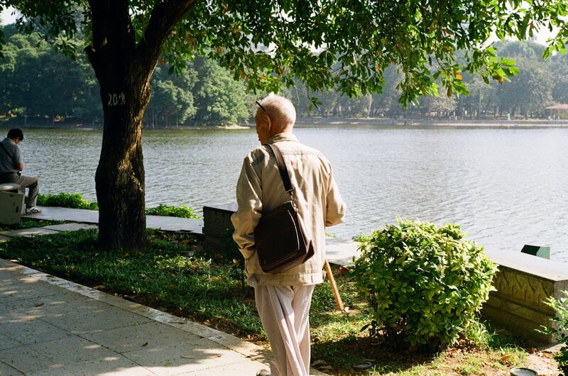Older adult walking outdoors breathing fresh air