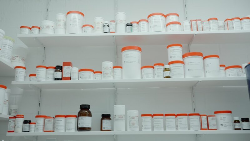 Pharmacy shelves with medication bottles