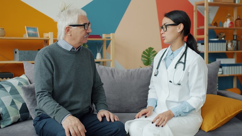 Older adult speaking with a healthcare professional during a consultation