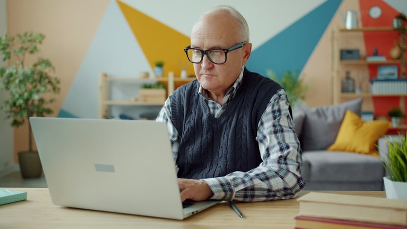 Older adult using a laptop for digital planning