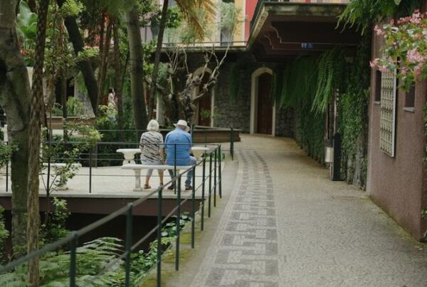 Older couple sitting together on a bench in a garden