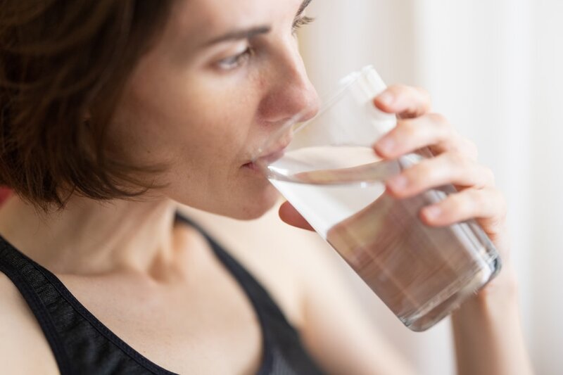 Older adult drinking water to stay hydrated