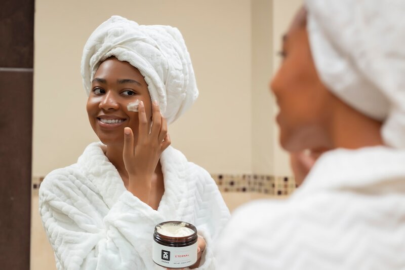 Older adult applying moisturiser for skin care